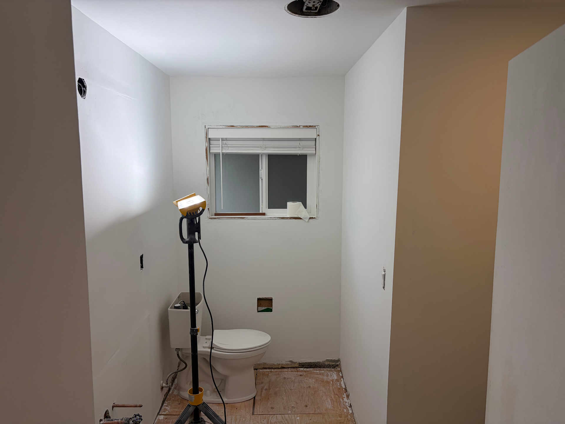 Hall bathroom during construction with new drywall, primed walls and exposed subfloor in Beaverton, Oregon